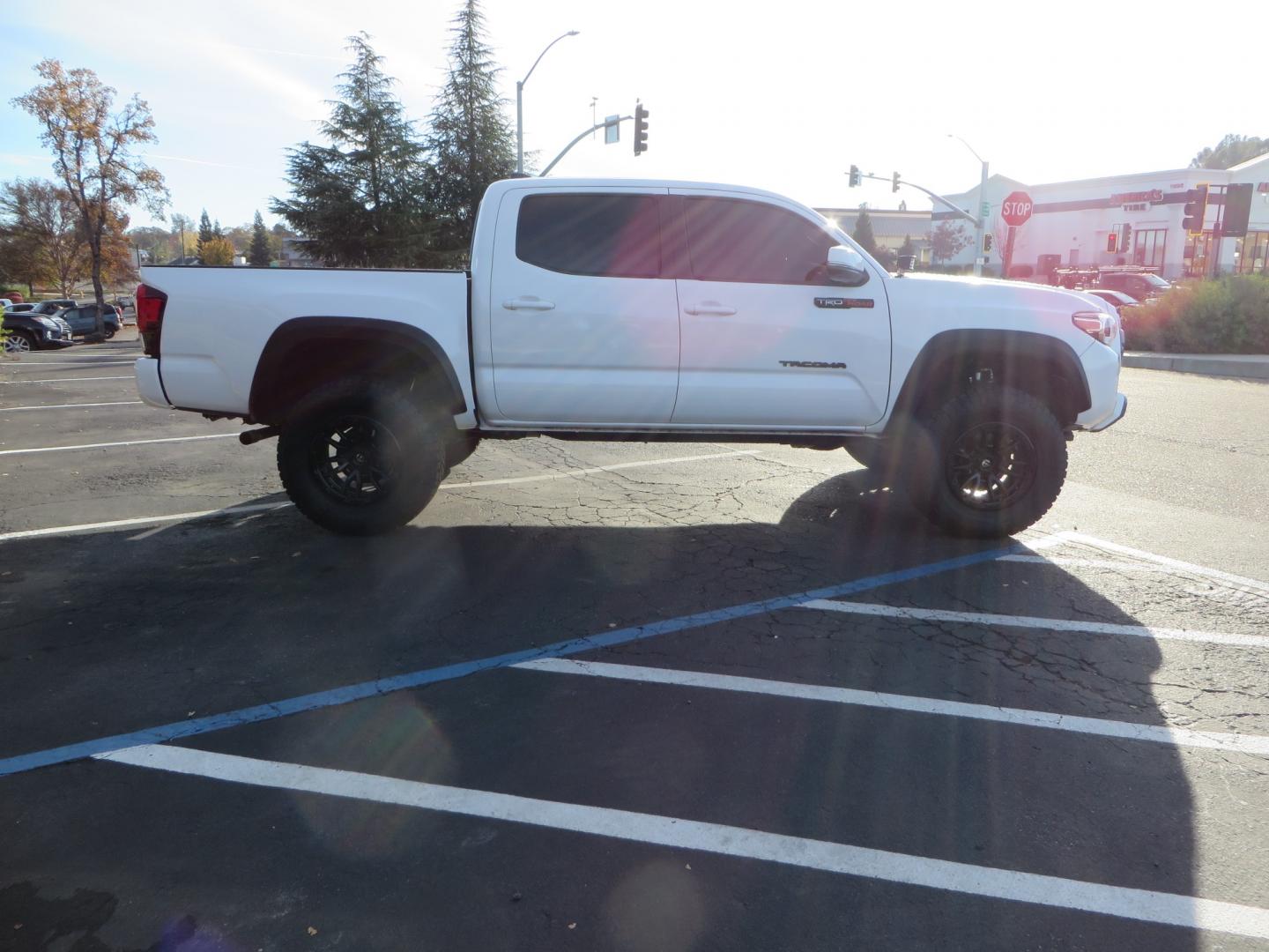 2019 White /black Toyota Tacoma TRD OFF-ROAD Double Cab (3TMAZ5CN4KM) with an 3.5L engine, automatic transmission, located at 2630 Grass Valley Highway, Auburn, CA, 95603, (530) 508-5100, 38.937893, -121.095482 - TRD Offroad 2WD sitting on Fox 2.5 remote reservoir DSC Coil-overs, Total Chaos upper control arms, Rigid Industries Dually side shooter leds, Fuel Rebel wheels, Nitto Ridge Grappler tires, and window tint. - Photo#3